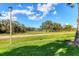 Beautiful landscape featuring a pond, mature trees, and well-maintained grass, perfect for enjoying nature at 3629 Longmeadow # 38, Sarasota, FL 34235