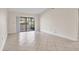 Spacious living room featuring tile floors and sliding glass doors to the lanai at 3629 Longmeadow # 38, Sarasota, FL 34235