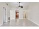 Open living room with neutral paint, tile floors, ceiling fan, and views into the kitchen at 3629 Longmeadow # 38, Sarasota, FL 34235