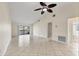 Large living area with tile flooring, a ceiling fan, sliding door access to the patio and views of the bathroom at 3629 Longmeadow # 38, Sarasota, FL 34235
