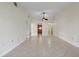 Open-concept living space featuring neutral tile flooring, ceiling fan, and natural light at 3629 Longmeadow # 38, Sarasota, FL 34235
