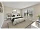 Bright main bedroom with a king bed, nightstands, and decor accents, flooded with natural light at 3629 Longmeadow # 38, Sarasota, FL 34235