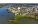 An aerial view of waterfront homes along a canal with mature trees and Gulf access at 400 Dona Dr, Nokomis, FL 34275