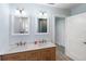 Elegant bathroom with a double vanity featuring marble countertops, complemented by modern lighting and fixtures at 400 Dona Dr, Nokomis, FL 34275