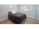 Serene bedroom with shuttered windows, wood-look flooring, and calming blue walls and decor at 400 Dona Dr, Nokomis, FL 34275