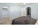 Comfortable bedroom with a ceiling fan, closet and views to additional rooms, featuring contemporary decor at 400 Dona Dr, Nokomis, FL 34275