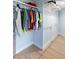 Functional closet with hanging rods and shelving offers ample storage space, complemented by wood-look flooring at 400 Dona Dr, Nokomis, FL 34275