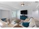 Bright living room features high ceilings, wood floors, cozy furniture, and lots of natural light at 400 Dona Dr, Nokomis, FL 34275