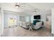 Bright, open-concept living room with high ceilings, wood floors, and cozy furniture at 400 Dona Dr, Nokomis, FL 34275