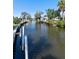 Picturesque waterfront canal with private docks surrounded by lush greenery and neighborhood homes at 400 Dona Dr, Nokomis, FL 34275
