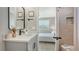 This bathroom has a stone counter, a view into the bedroom, and a tiled shower at 4207 Marina View Way, Cortez, FL 34215