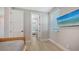 This minimalist bedroom features wood-look flooring, neutral colors, and a mounted TV at 4207 Marina View Way, Cortez, FL 34215