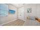 This cozy bedroom features wood-look flooring, neutral colors, and a mounted TV at 4207 Marina View Way, Cortez, FL 34215