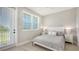 This bedroom has light-colored wood floors, a large window, and neutral decor at 4207 Marina View Way, Cortez, FL 34215