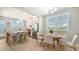 Bright dining area featuring a table with chairs and a kitchen island with counter seating at 4207 Marina View Way, Cortez, FL 34215