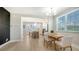 An open dining room featuring a wooden table and modern white chairs near a kitchen at 4207 Marina View Way, Cortez, FL 34215