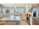 Modern kitchen featuring white cabinetry, stainless steel appliances, and an island at 4207 Marina View Way, Cortez, FL 34215