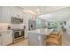 Modern kitchen featuring stainless steel appliances, and marble counters, with island seating at 4207 Marina View Way, Cortez, FL 34215