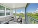 Serene lanai featuring comfortable seating and a beautiful view of lush greenery under a bright, sunny sky at 4207 Marina View Way, Cortez, FL 34215