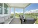 Inviting lanai with ample seating to enjoy expansive views of lush greenery under a bright, sunny sky at 4207 Marina View Way, Cortez, FL 34215