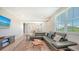 Bright living room featuring a large leather sofa, stylish rug and modern decor at 4207 Marina View Way, Cortez, FL 34215