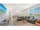 Open concept living room with a leather sectional sofa, TV, and a view into the kitchen and dining room at 4207 Marina View Way, Cortez, FL 34215