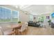 Open floor plan showcasing the bright living room, dining area, and outdoor patio at 4207 Marina View Way, Cortez, FL 34215