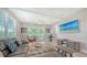 A spacious living room with a comfortable sectional sofa, a ceiling fan and sliding glass doors to the exterior balcony at 4207 Marina View Way, Cortez, FL 34215