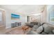 Bright living room featuring a large leather sofa, stylish rug and modern decor at 4207 Marina View Way, Cortez, FL 34215