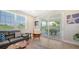 A spacious living room with a comfortable sectional sofa, a ceiling fan and sliding glass doors to the exterior balcony at 4207 Marina View Way, Cortez, FL 34215