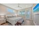 Bright main bedroom featuring a ceiling fan, ensuite doors to lanai, and a king bed with neutral bedding at 4207 Marina View Way, Cortez, FL 34215