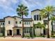 Elegant multi-story building with palm trees, offering a blend of modern and classic design elements at 430 Kumquat Ct # 206, Sarasota, FL 34236