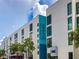 Modern white building showcasing 'Sarasota Opera' sign, complemented by palm trees and blue sky at 430 Kumquat Ct # 206, Sarasota, FL 34236