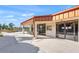 Outdoor building exterior with covered seating, walkway, and well maintained landscaping at 4410 Murfield E Dr, Bradenton, FL 34203