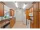 Galley kitchen offers ample counter space, wood cabinetry, and modern appliances, perfect for meal preparation at 4410 Murfield E Dr, Bradenton, FL 34203