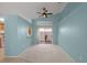 Blue-walled living room features a ceiling fan and sliding glass door access to a private courtyard at 4410 Murfield E Dr, Bradenton, FL 34203
