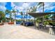 Stylish outdoor lounge with comfortable seating, sun shade, and elegant patio at 4410 Murfield E Dr, Bradenton, FL 34203