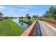 Scenic view of a pond on the golf course, with lush green landscaping and a charming wooden bridge at 4410 Murfield E Dr, Bradenton, FL 34203