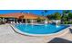 Outdoor pool with lounge seating and lush landscaping on a sunny day at 4410 Murfield E Dr, Bradenton, FL 34203