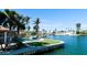 Waterfront backyard featuring a pool, lush lawn, tropical landscaping, and stunning water views at 542 67Th St, Holmes Beach, FL 34217