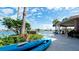 Beautiful backyard with lush landscaping, a sparkling pool, and kayaks for waterfront adventures at 542 67Th St, Holmes Beach, FL 34217