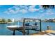 Waterfront property featuring a boat lift for easy access to boating and water activities at 542 67Th St, Holmes Beach, FL 34217