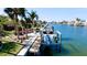 Scenic view of a private boat dock with a lift, surrounded by lush tropical landscaping at 542 67Th St, Holmes Beach, FL 34217