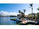 Charming waterfront scene showcasing a boat dock, lush landscaping, and serene canal views at 542 67Th St, Holmes Beach, FL 34217