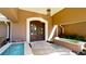 Inviting home entrance featuring an arched entryway, double doors and a courtyard pool at 542 67Th St, Holmes Beach, FL 34217