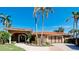 Beautiful home exterior featuring a tile roof, double garage, lush landscaping, and a well-manicured lawn at 542 67Th St, Holmes Beach, FL 34217