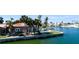 Waterfront home with a pool, lush lawn, tropical trees, and beautiful views of the canals at 542 67Th St, Holmes Beach, FL 34217