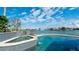 Inviting pool and spa with waterfront views under a beautiful blue, partly cloudy sky at 542 67Th St, Holmes Beach, FL 34217