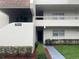Inviting condo exterior featuring well-maintained landscaping, clean facade, and unit number for easy identification at 7211 W Country Club N Dr # 135, Sarasota, FL 34243