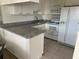Well-equipped kitchen with granite countertops, white cabinetry, and appliances, offering ample counter space at 7211 W Country Club N Dr # 135, Sarasota, FL 34243
